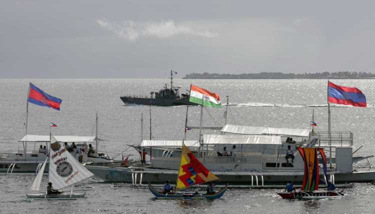 A philippine navy boat patrols infront of other boats