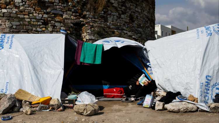 Ein Migrant liest ein Buch vor seinem Zelt in dem von der Gemeinde Souda betriebenen Lager für Flüchtlinge und Migranten auf der Insel Chios, Griechenland